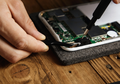 Smartphone technician repairing mobile phone in Al Barsha