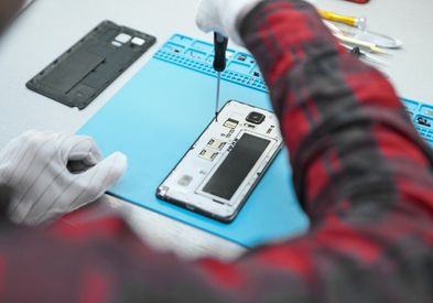 Mobile repair technician fixing a phone camera in Al Barsha Dubai